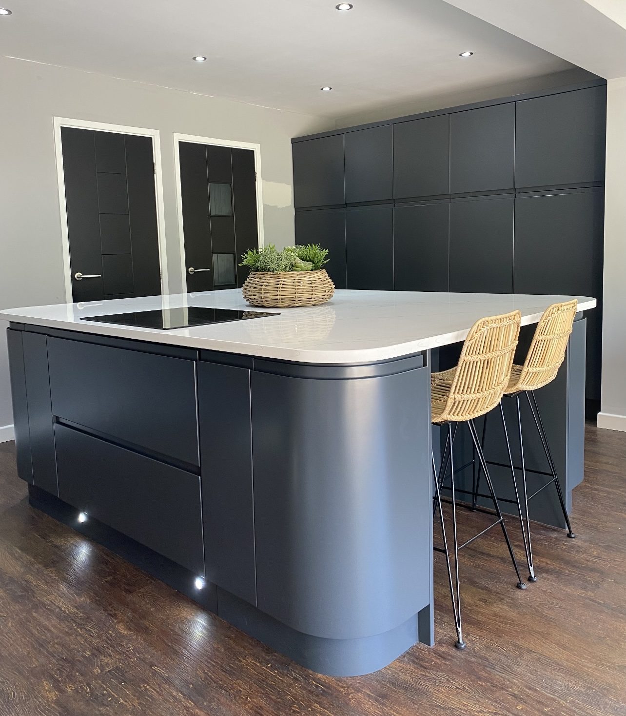 A kitchen island and tall units sprayed anthracite grey