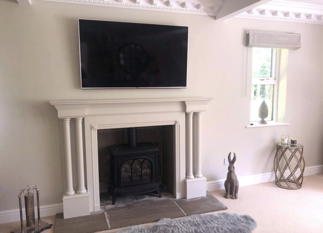 A living room with the fire surround painted white