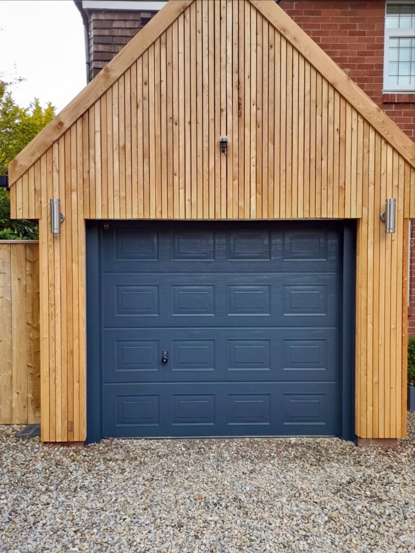 A garage door sprayed dark blue in a timber-clad garage