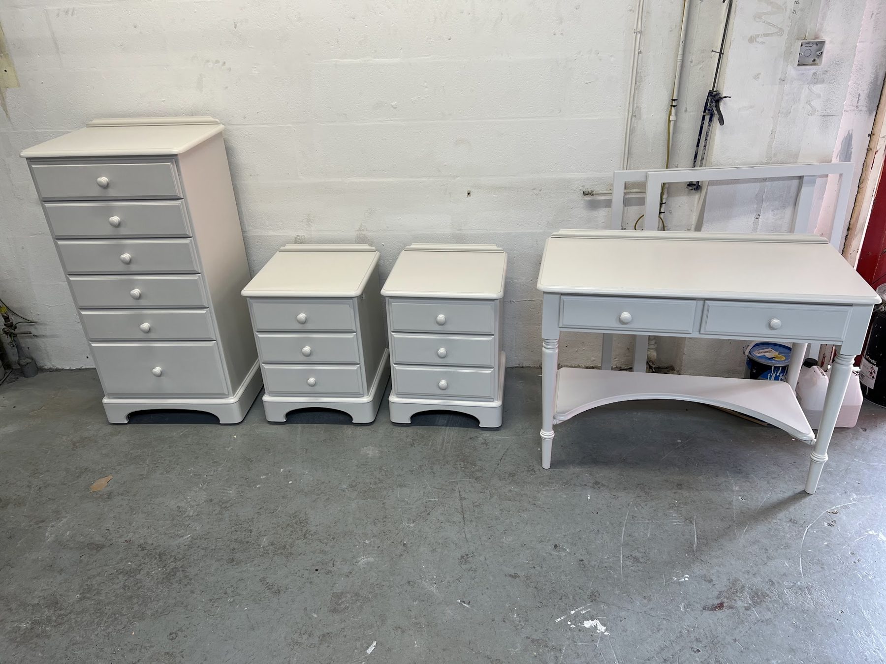 A chest of drawers, bedside tables and a dressing table sprayed grey